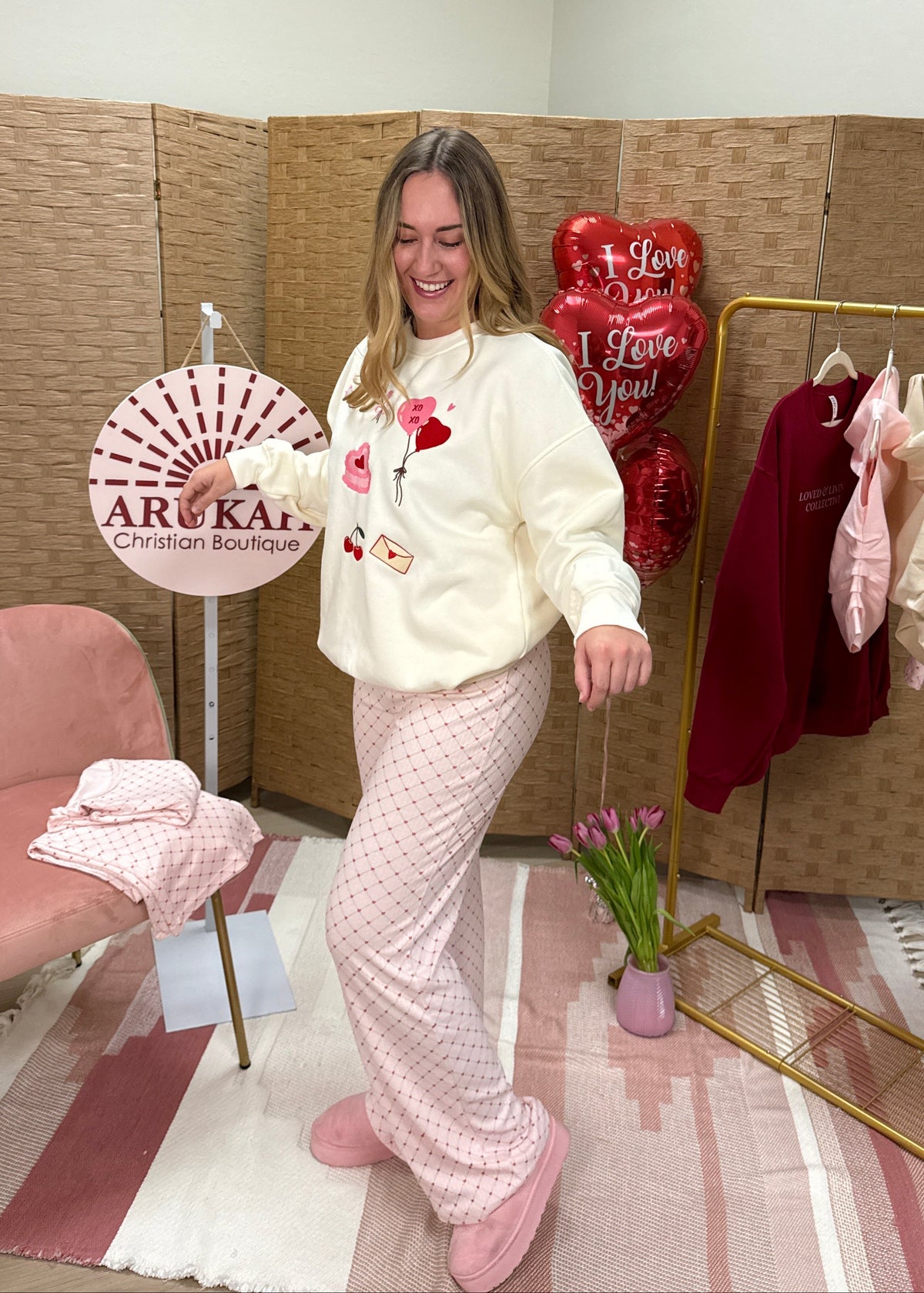 Woman showcasing a valentine's themed embroidered rewneck