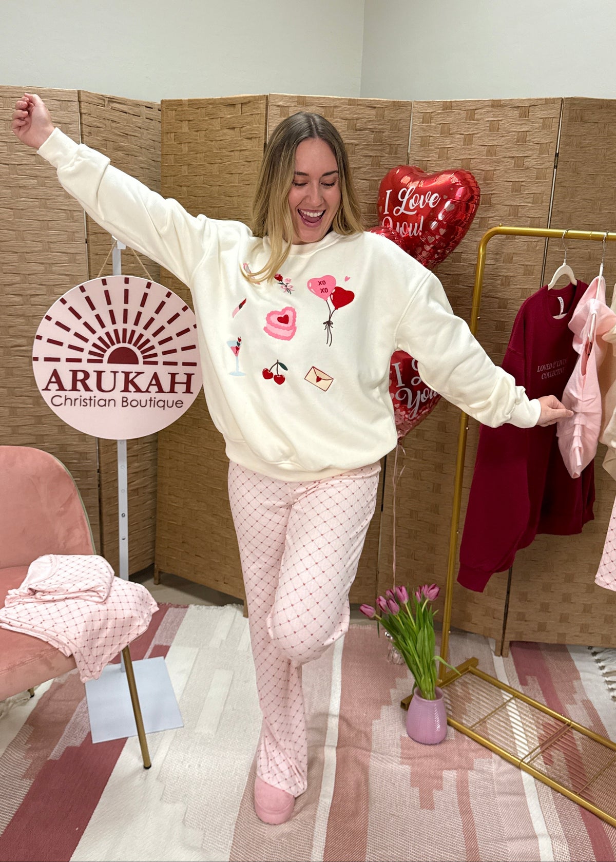 Woman in a white sweatshirt with heart designs 