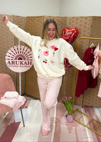 Woman in a white sweatshirt with heart designs 