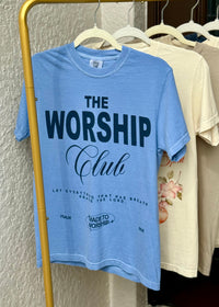 Blue t-shirt with 'The Worship Club' text on a rack with other shirts.