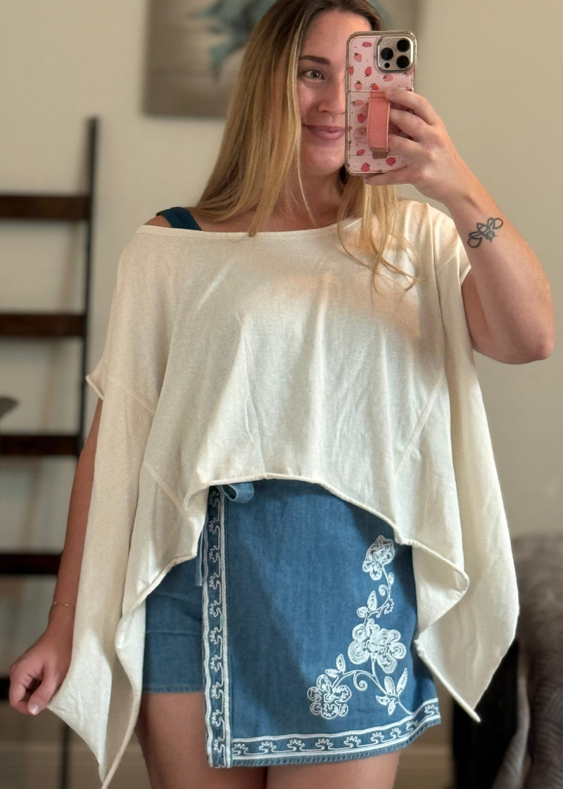 woman wearing a super versatile, cream colored flowy top