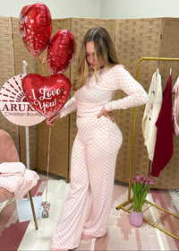 women wearing a heart pattern pajama set with a cute valentine's themed background