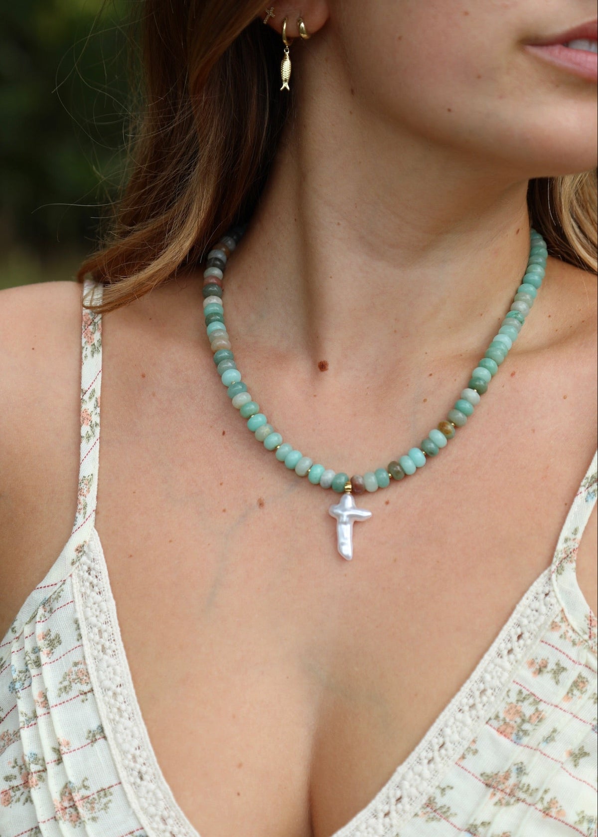 teal beaded necklace with baroque cross pendant