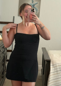 young woman wearing black active dress with pockets, athleisure outfit inspiration